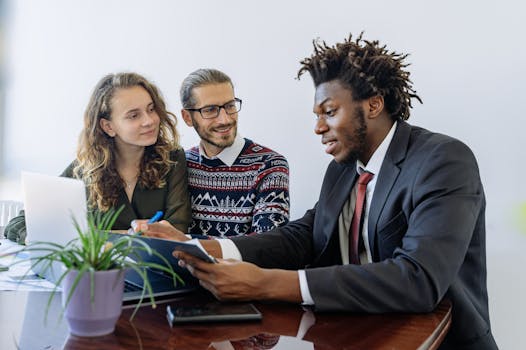 A diverse group of professionals collaborating in an office meeting, showcasing teamwork and partnership.